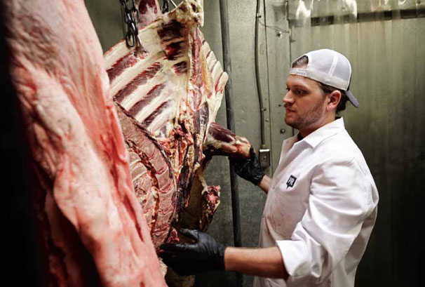 butcher with meat in uniform